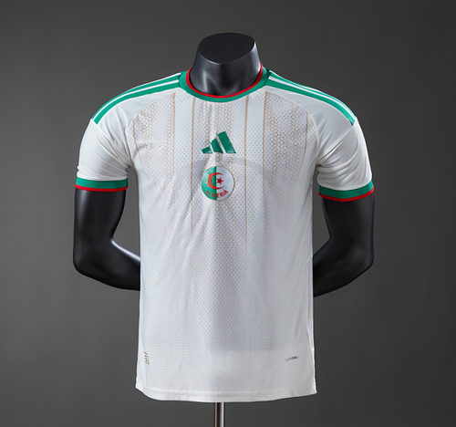 White sports jersey with green and red accents on a black mannequin against a gray background