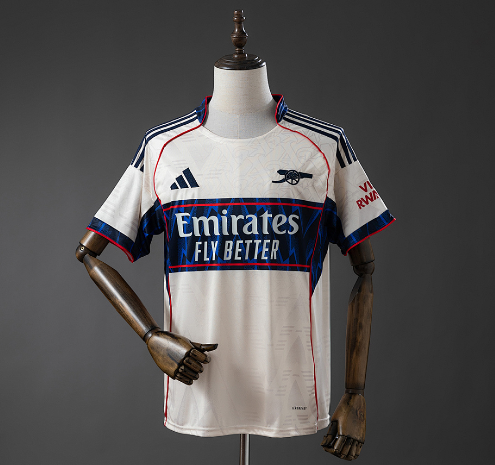 White sports jersey with red and blue accents on a mannequin against a gray background, Arsenal 25/26 Pre-Match- Beige Jersey , 11culture, 11 culture