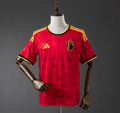 Red sports jersey with yellow accents on a mannequin against a gray background,Belgium 2026 Home Jersey , BELGIUM