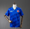 Blue sports jersey with a logo on a mannequin against a gray background,  Columbia 1994 Away Retro Jersey, 11 culture, 11culture