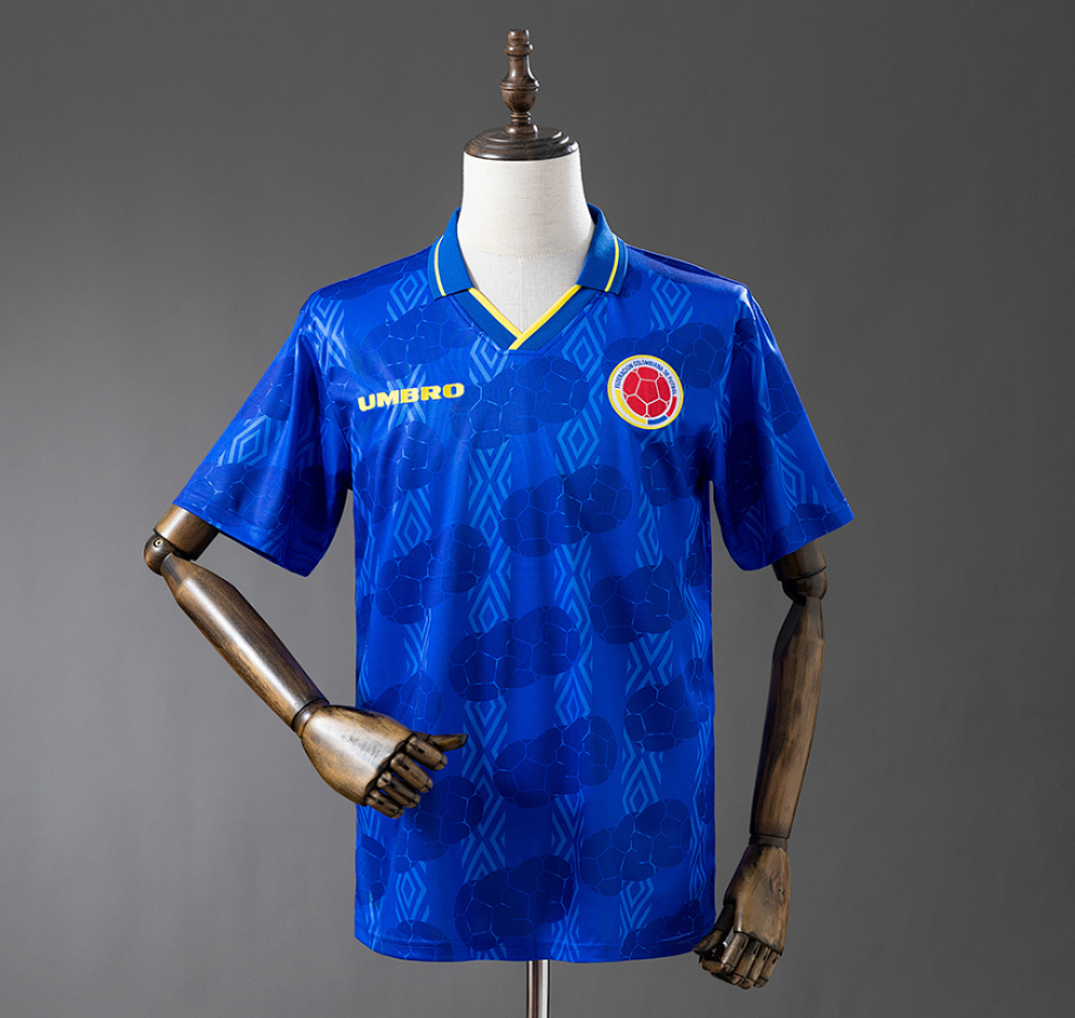 Blue sports jersey with a logo on a mannequin against a gray background,  Columbia 1994 Away Retro Jersey, 11 culture, 11culture