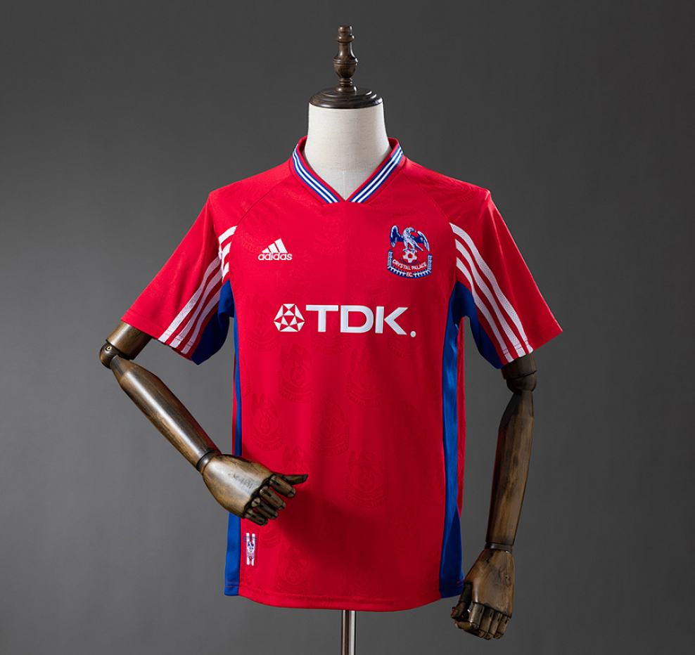 Red sports jersey with Adidas and TDK logos on a mannequin against a gray background, Crystal Palace 98/99 Home Retro Jesery, 11culture, 11 culture, original jerseys