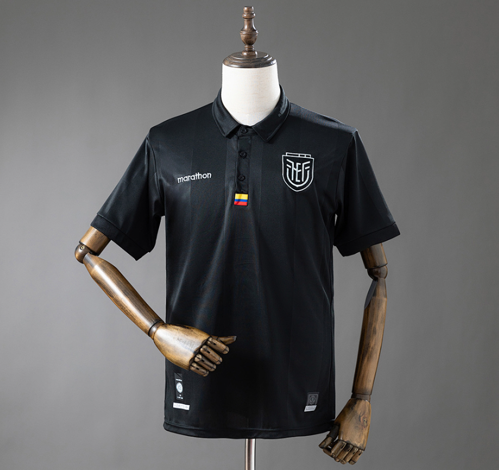 Black polo shirt with logos on a mannequin against a gray background