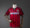 Red sports jersey with Tetra Pak logo on a mannequin against a gray background, 11 culture, 11culture