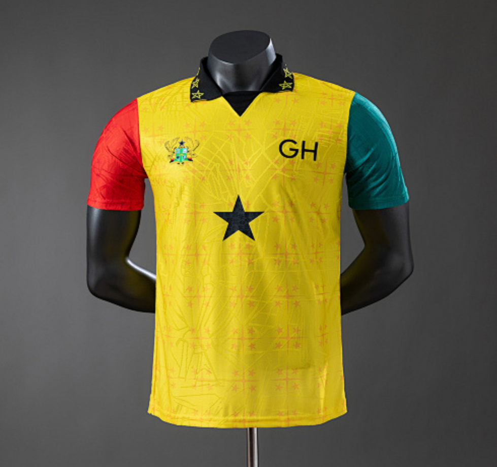 Yellow sports jersey with red and green sleeves on a mannequin against a gray background