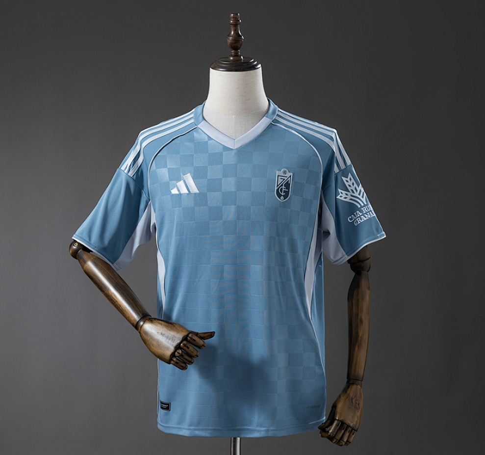 Light blue sports jersey with Adidas logo on a mannequin against a gray background, 11culture, 11 culture