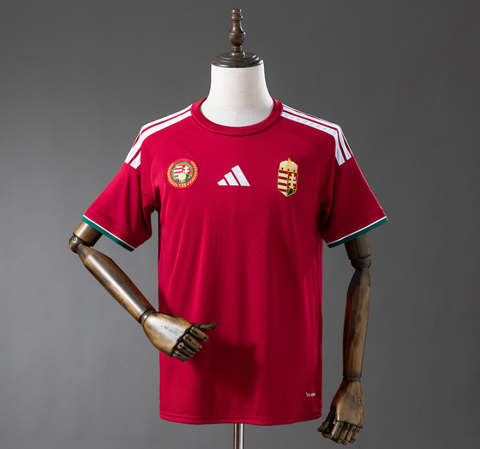 Red sports jersey with Adidas logo on a mannequin against a gray background, Hungary 2026 Home Jersey , 11 culture, 11culture