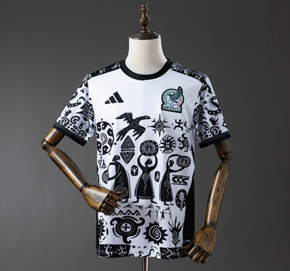 White sports jersey with black patterns on a mannequin against a gray background, Mexico 25/26 Special Edition Jersey