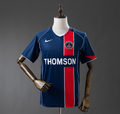 Blue and red sports jersey with 'Thomson' branding on a mannequin against a gray background, PSG 04/05 Home Retro Jesery, PSG, 11culture, 11 culture