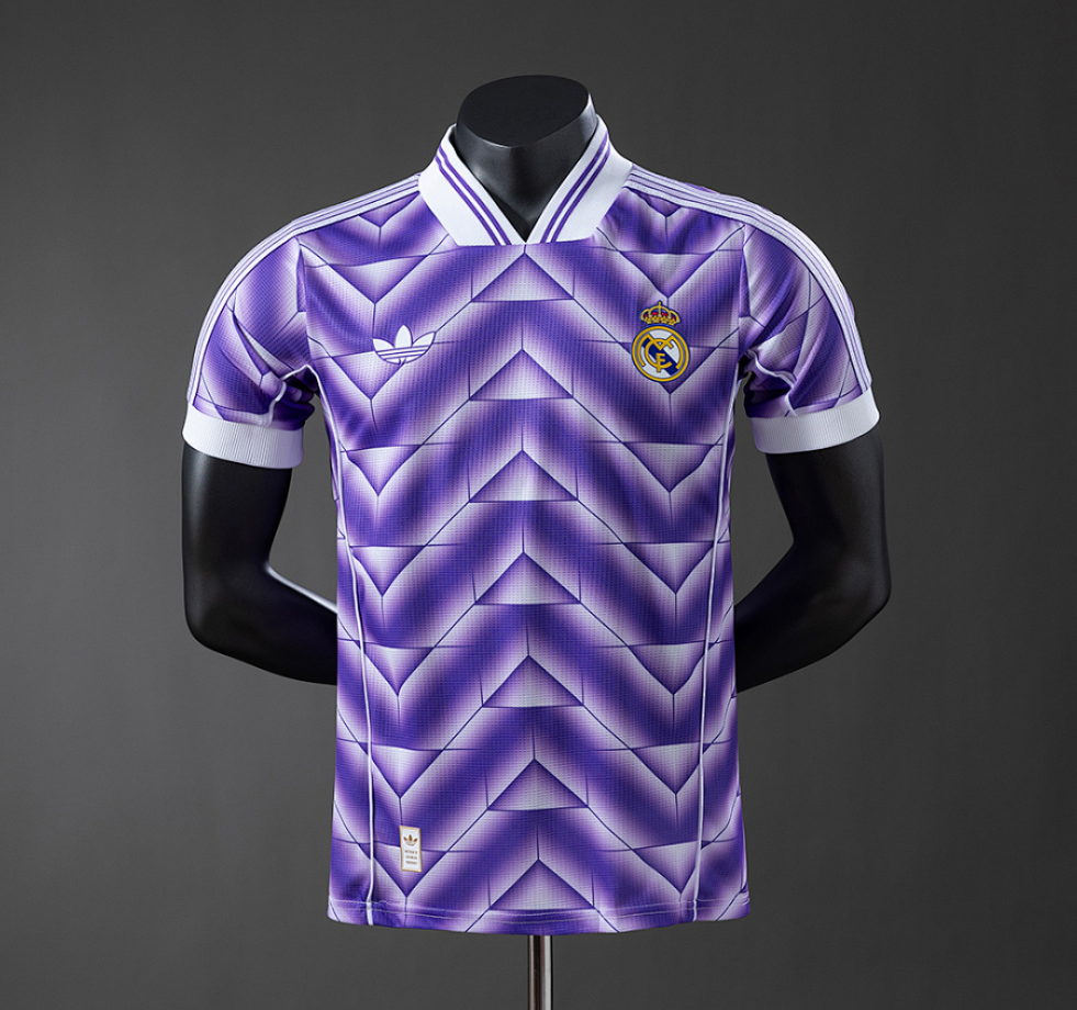 Purple and white sports jersey with Adidas and Real Madrid logos on a mannequin against a dark background.