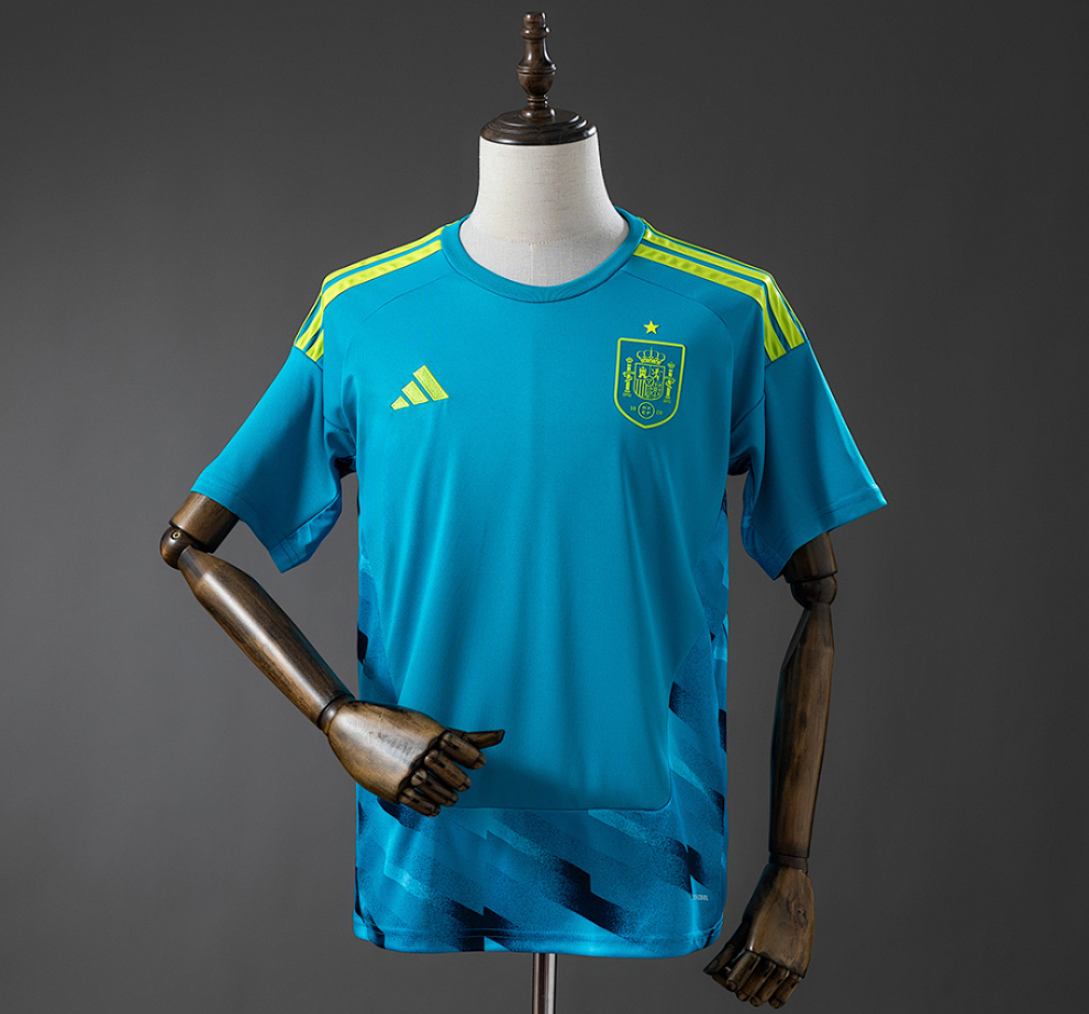 Blue sports jersey with green accents on a mannequin against a gray background