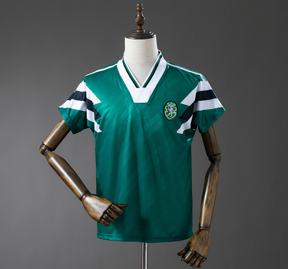 Green sports jersey with white and black stripes on a mannequin against a gray background, Sporting Lisbon Retro-Green Jersey. 11CULTURE